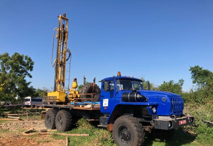 Borehole drilling rig at work on site.